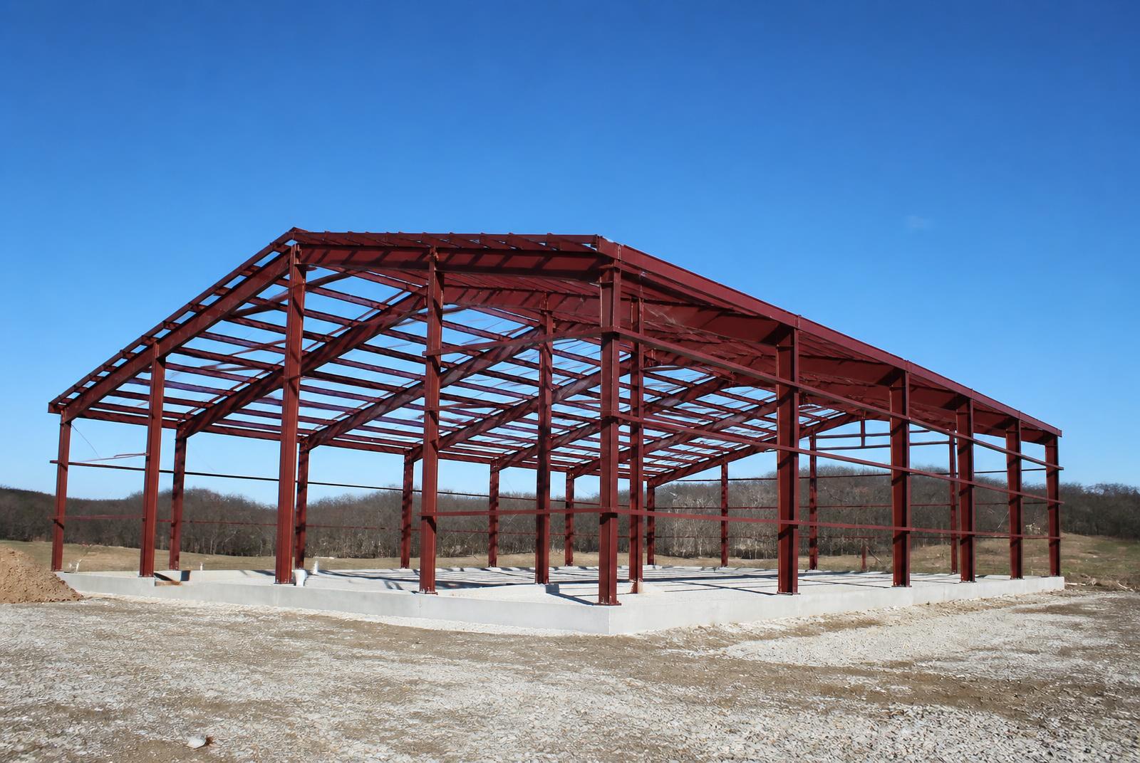 Representative image of a red iron steel frame on a concrete foundation